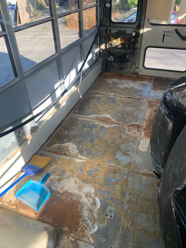 Bus interior, showing bare metal floor with surface rust